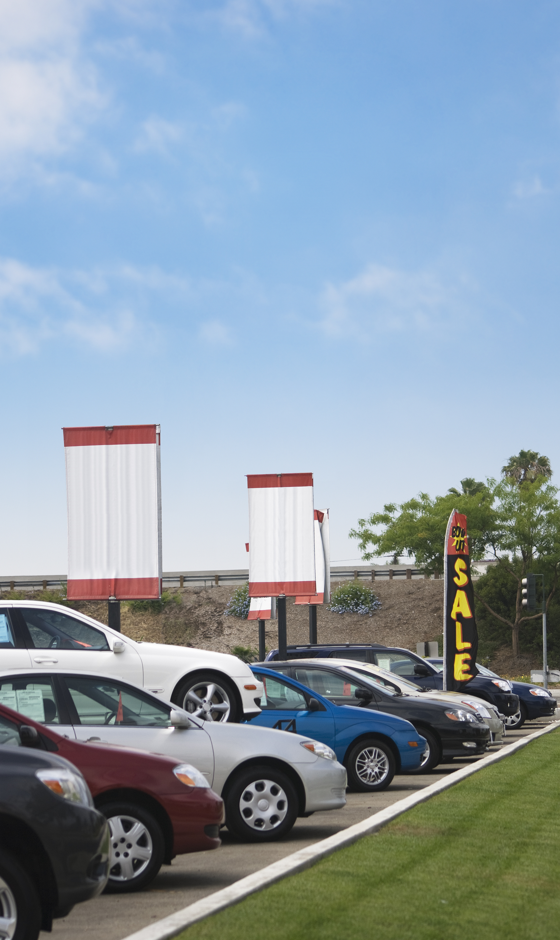 A row of cars for sale at a car dealership.    Similar pictures: